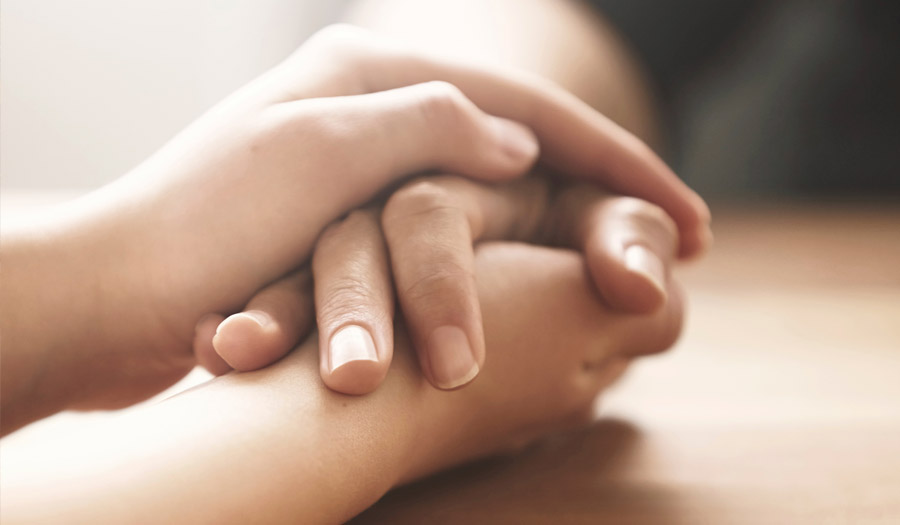 image of hands holding for blog about the 5 observations of grief