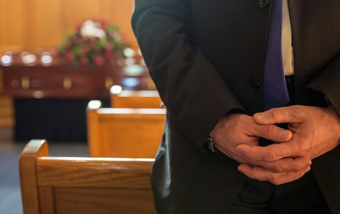 image of a man in a pue in a church for an ITIJ blog about Rowland Brothers International Services